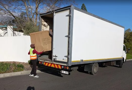 Movers carrying boxes from a Pinelands home near Epping, Cape Town