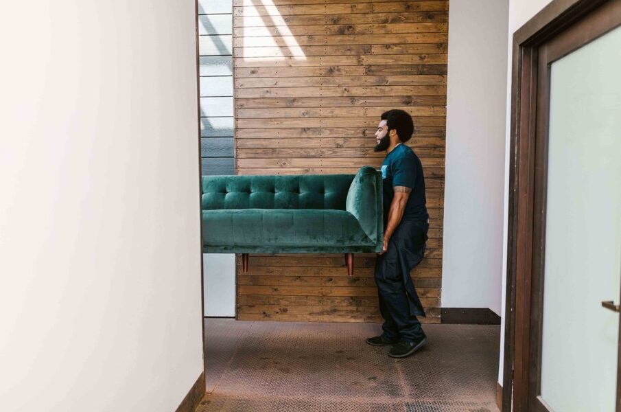 Furniture movers carrying household items in Cape Town suburb